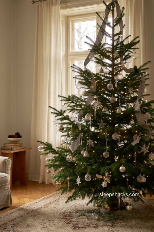 Silver ribbon crystal christmas tree with cascading metallic ribbon sparkling ornaments warm white lights and elegant winter decor 