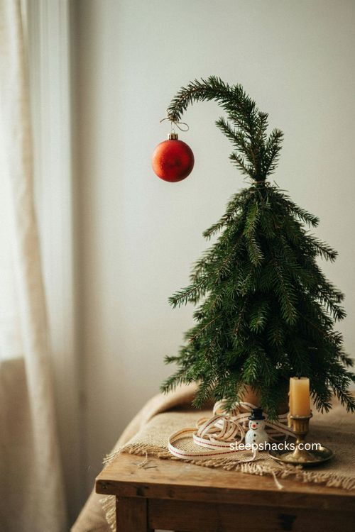 Single red ornament diy grinch tree topper with curved green branch