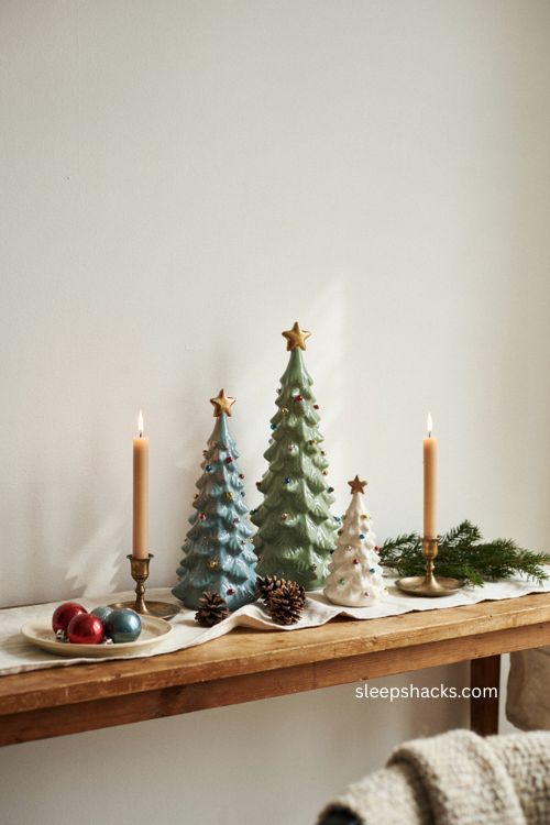 Small ceramic christmas trees arranged for a cozy apartment entryway and windowsill