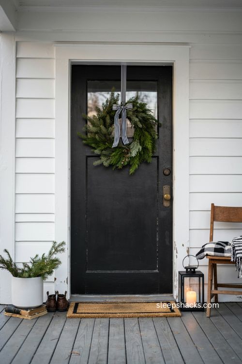 Small porch Christmas decor in black white and green farmhouse style 