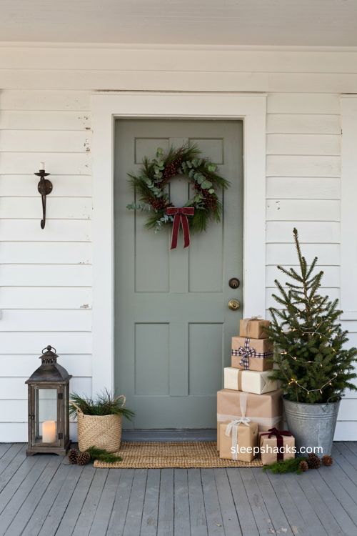 Small porch Christmas decor with stacked wrapped gift boxes and mini tree 