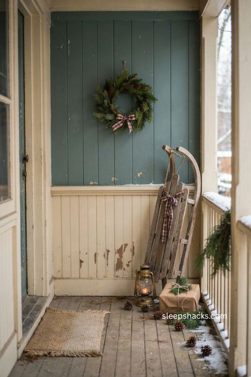 Small porch Christmas decor with vintage sled plaid ribbon and greenery 