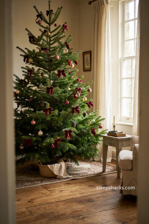 Small velvet bows scattered throughout a Christmas tree with tiny lights 