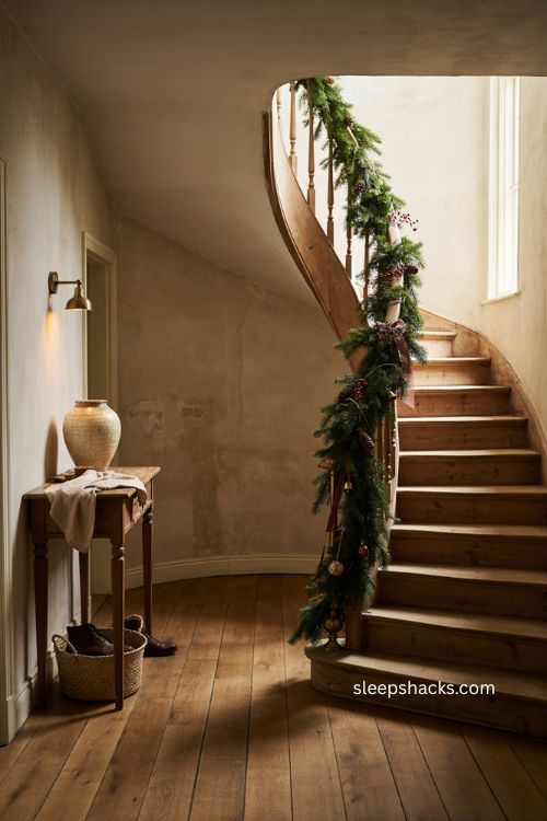 Spiral staircase Christmas garland with greenery and red berries