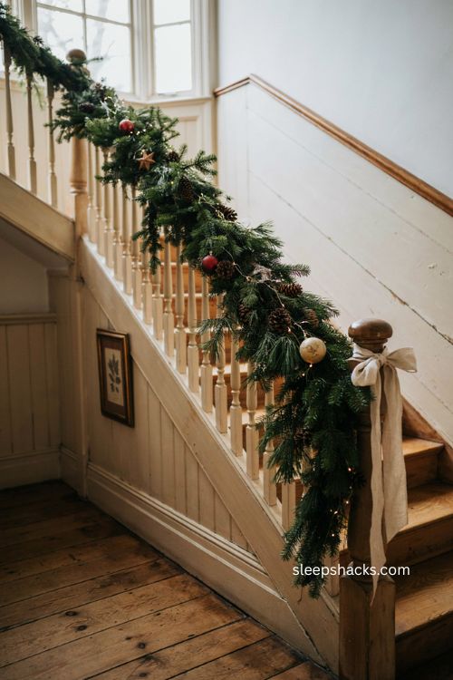 Staircase banister garland Christmas decor with pinecones and bow