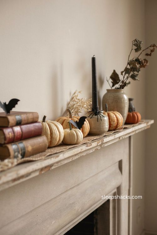 Subtle Halloween fall mantle with pumpkins bats and black candlesticks 