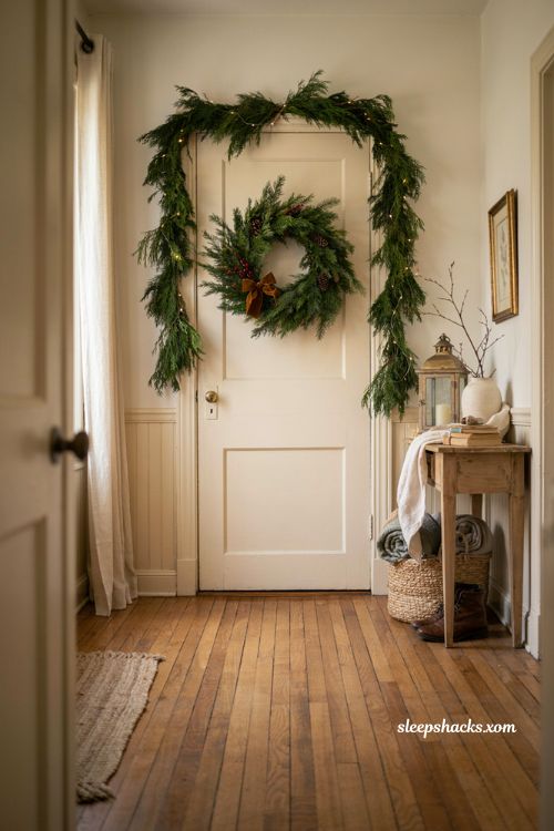 Thanksgiving Christmas decor with deep green wreath and versatile entryway greenery
