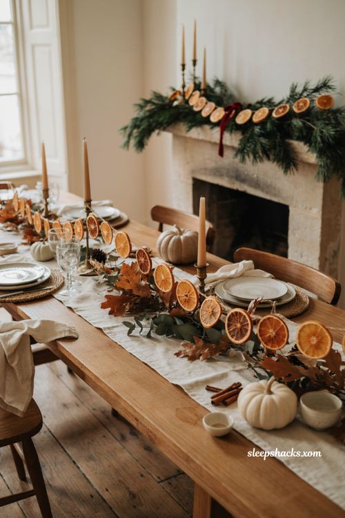 Thanksgiving Christmas decor with dried orange garland and evergreen mantel