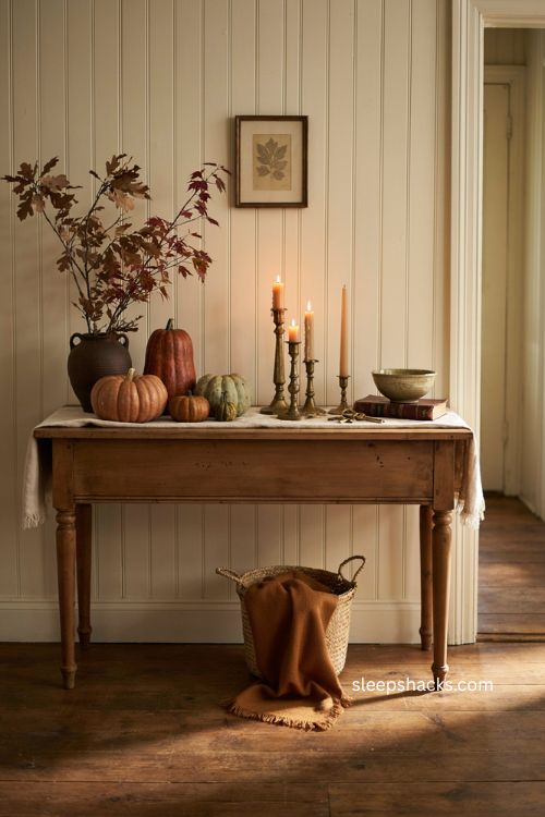 Thanksgiving entryway console table with candles pumpkins and autumn decor 