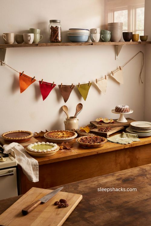 Thanksgiving felt pie slice garland above a cozy kitchen buffet with real pies and rustic fall decor
