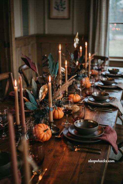 Moody Thanksgiving tablescape with dark dishware paper centerpiece and candlelight