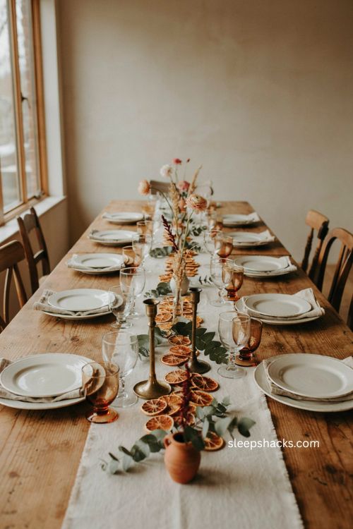 Thanksgiving table centerpiece with dried orange slices eucalyptus and flowers 