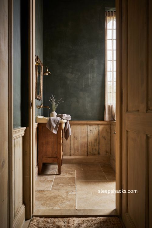 Timeless bathroom with textured wood flooring dark walls vintage vanity and warm natural details 