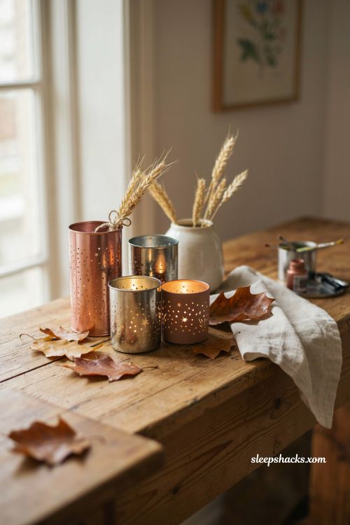 Tin punched votive candles with warm fall decor and glowing leaf patterns 