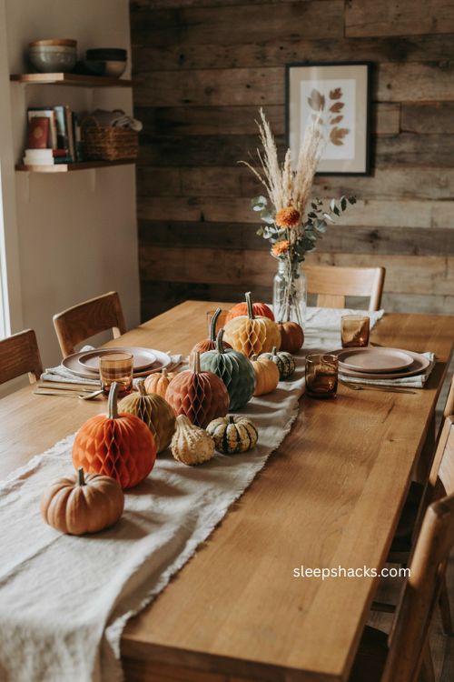 Tissue paper honeycomb pumpkins with real gourds for a cozy halloween table centerpiece 