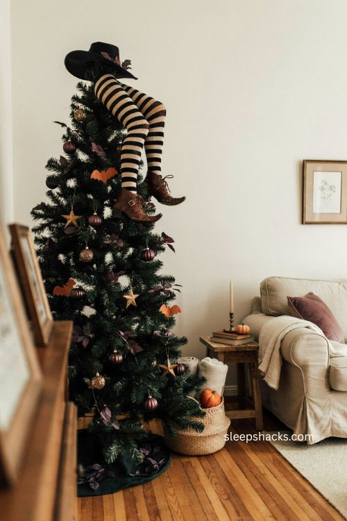 Upside down witch legs topper on a black halloween tree with striped stockings 