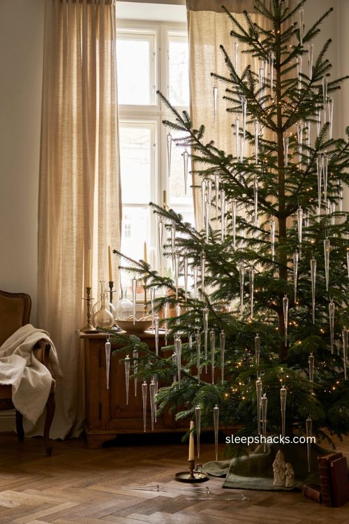 Varied length icicle Christmas tree with layered clear glass ornaments