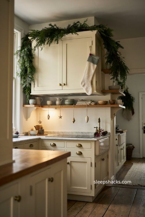 Vertical Christmas kitchen decor with garland on range hood and open shelves 