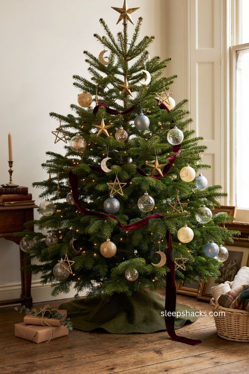 Vintage celestial Christmas tree with antique stars moons and faded glass ornaments