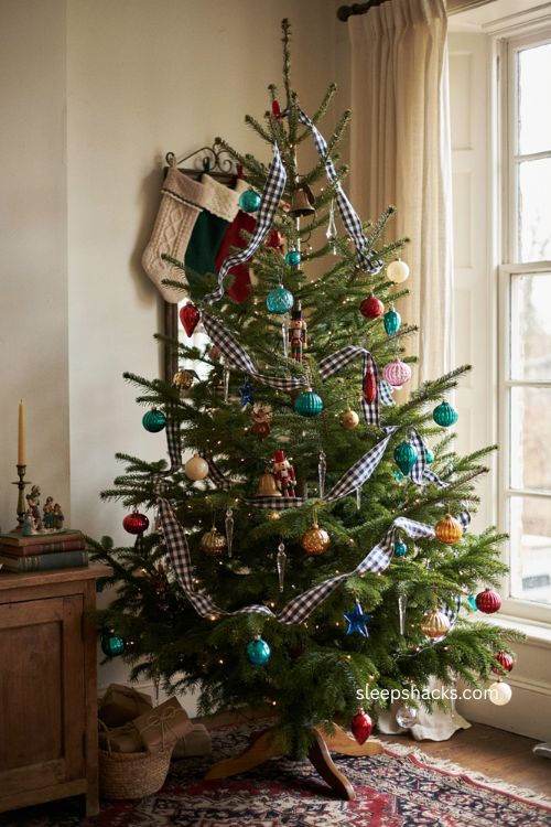 Vintage colorful Christmas tree with navy and white checked ribbon and mismatched ornaments
