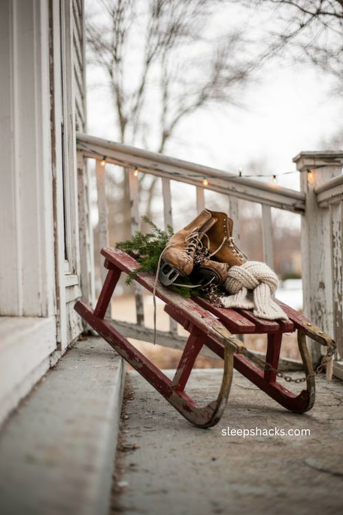 Vintage sled Christmas decor with old ice skates and evergreen sprigs 