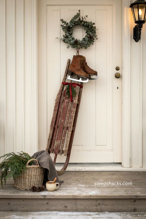 Vintage sled Christmas porch decor with greenery and ice skates 
