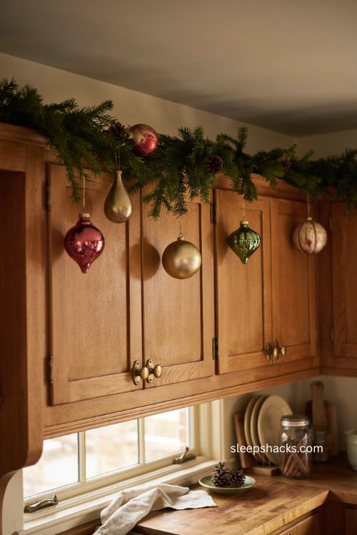 Vintage style Christmas ornaments on cozy farmhouse kitchen cabinets 
