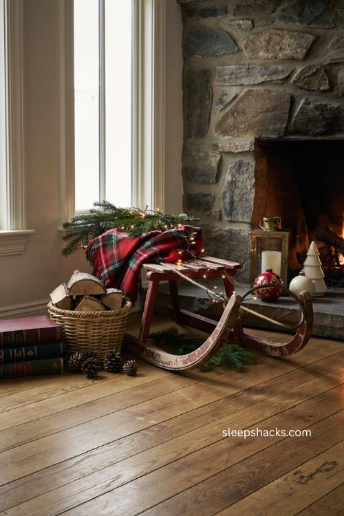 Vintage wooden sled decor with pine branches plaid blanket and cozy nostalgic Christmas fireplace 