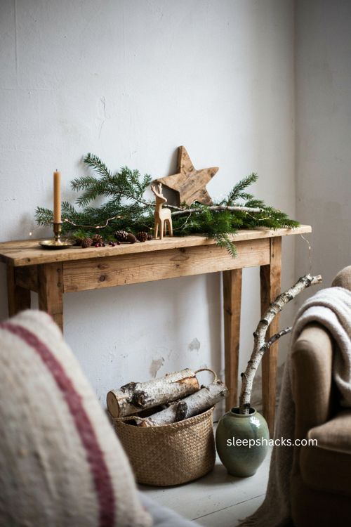 Warm Christmas decor layered with natural wood birch wool and greenery 