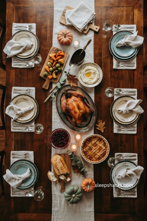 Warm wooden Thanksgiving table with turkey pumpkin pie and rustic autumn spread 
