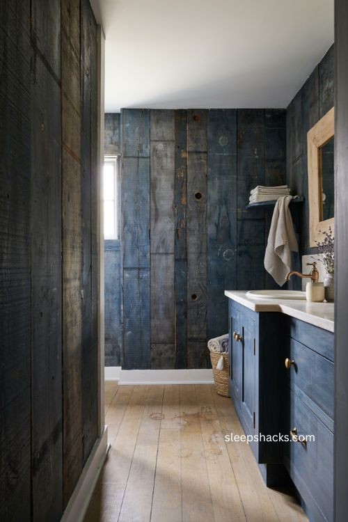 Weathered blue wood bathroom with matching vanity light wood mirror and stone countertop 