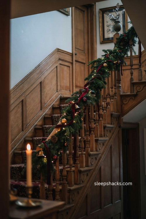 Whimsigoth christmas staircase garland with burgundy velvet ribbon brass bells and warm lights
