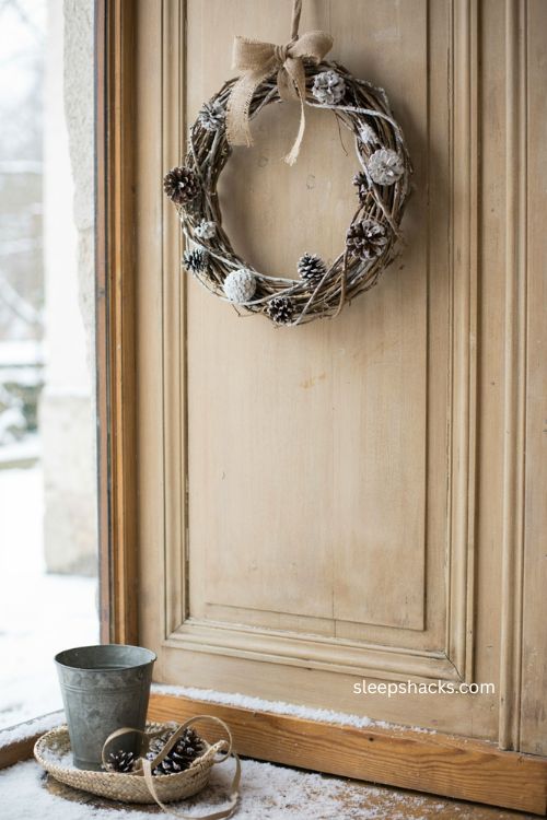 White painted twig Christmas wreath with pinecones and jute ribbon 