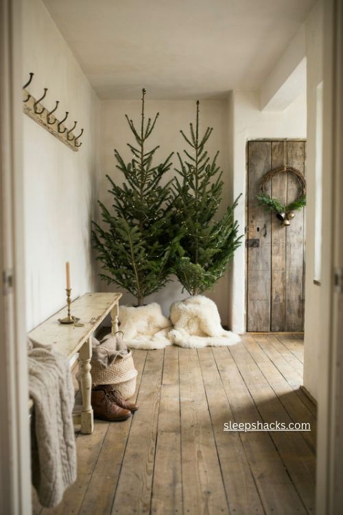 bare fir christmas trees with faux fur skirts in a cozy cottage mudroom 