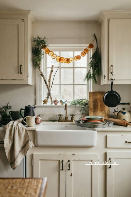 cozy cottage christmas kitchen with dried oranges pine greenery and thrifted decor 
