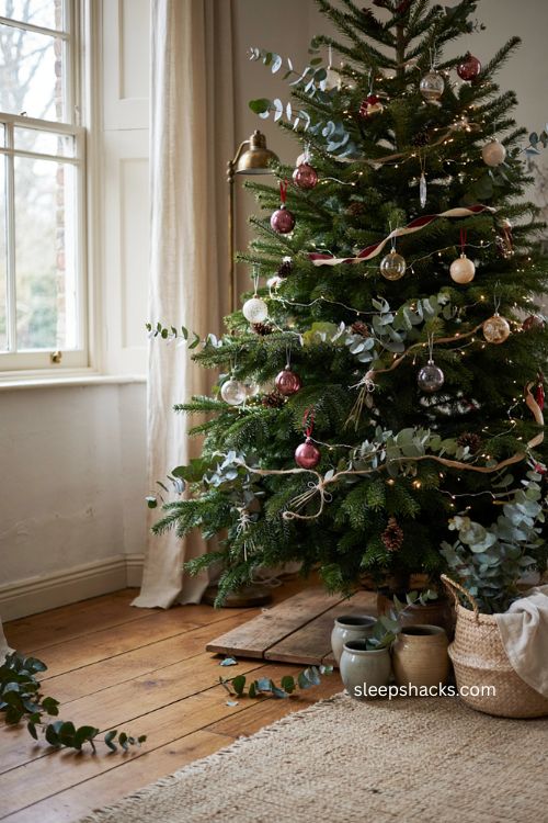 eucalyptus garland layered on a traditional christmas tree 
