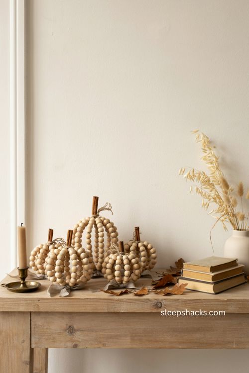 fall diy wood bead pumpkin with cinnamon stick stem and neutral farmhouse decor 