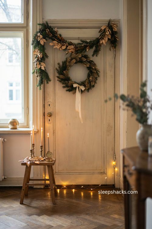 gold spray painted Christmas garland with matching wreath and vintage entryway decor 