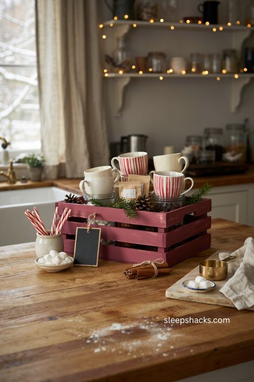 hot cocoa bar crate with Christmas mugs marshmallows cocoa candy canes and rustic farmhouse kitchen decor 