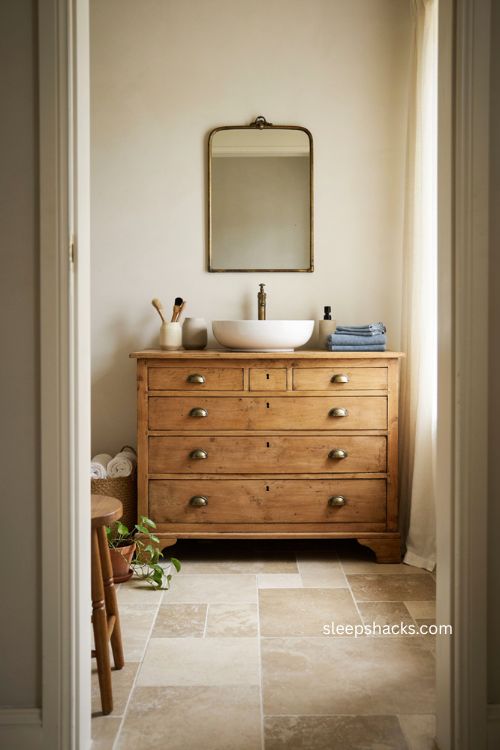 modern farmhouse bathroom with antique dresser vanity and stone countertop 