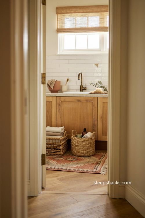 modern farmhouse bathroom with woven kilim rug rattan baskets and natural textures 