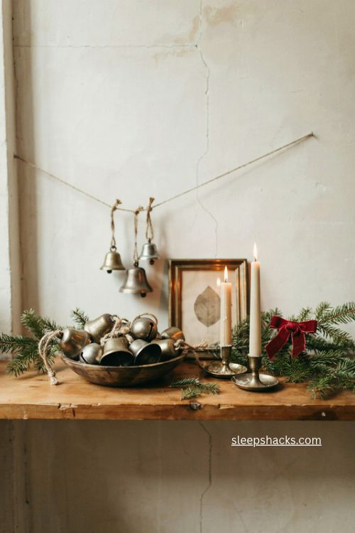oversized vintage bells christmas console table decor with evergreen branches and red velvet bow 