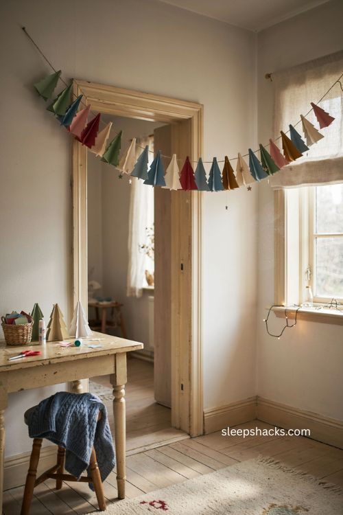 paper Christmas tree chain with colorful cardstock trees and glitter stars 