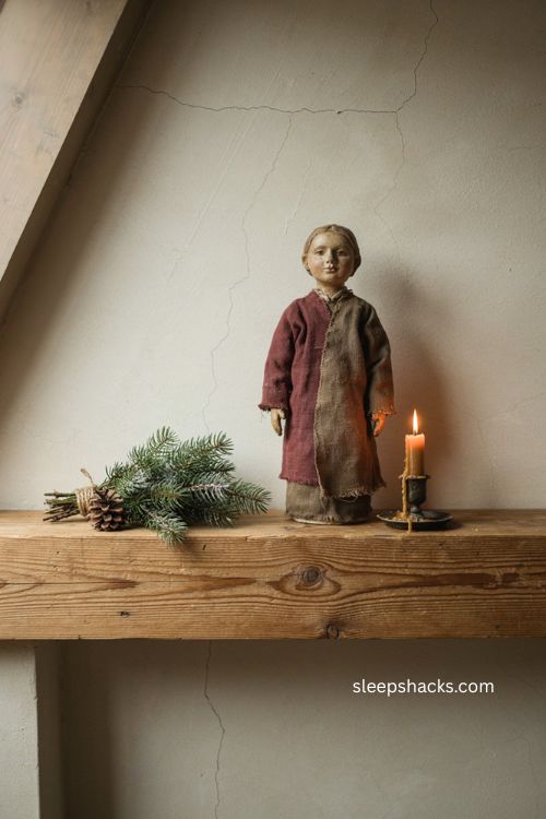 primitive Christmas Belsnickel figure on rustic mantel with folk art decor 
