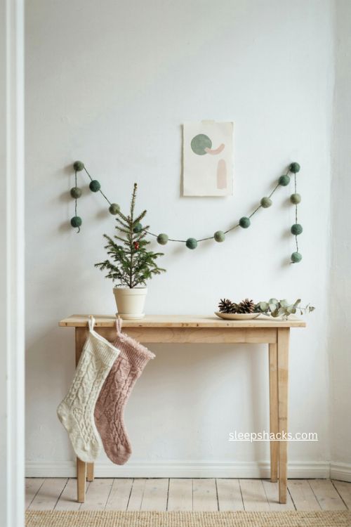scandinavian pompom garland and stockings christmas console table entryway decor