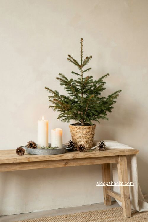 single potted evergreen tree console table christmas decor with candles and pinecones 