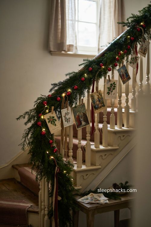 vintage christmas card garland with balsam fir cedar greenery and red ornaments on staircase 