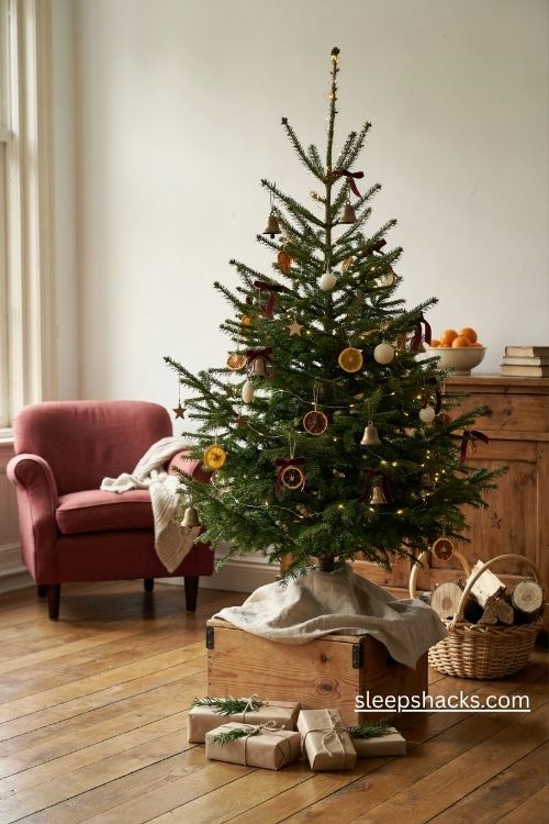 4ft Christmas tree decorating ideas with a rustic wooden crate and linen tree skirt