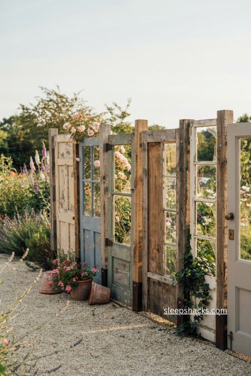 Affordable salvaged doors and windows fence ideas with reclaimed wood for a vintage garden 