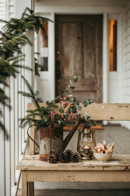 Antique watering can christmas planter with pine berries and eucalyptus